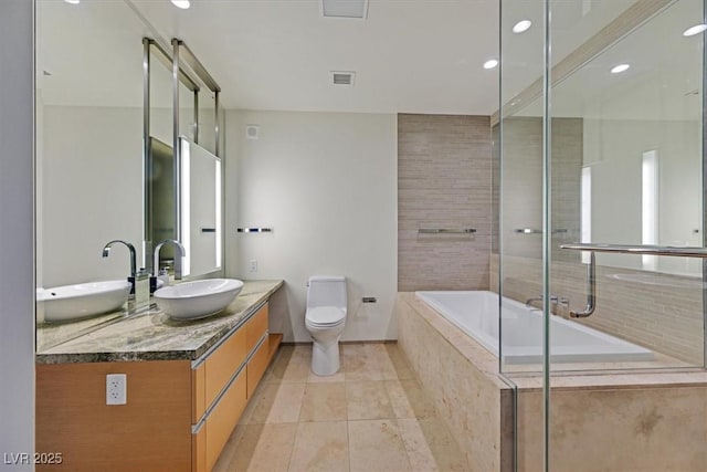 3726 Las Vegas Blvd Unit 1902, Las Vegas, NV 89158 - bathroom featuring tiled tub, toilet, tile patterned flooring, double vanity, and recessed lighting
