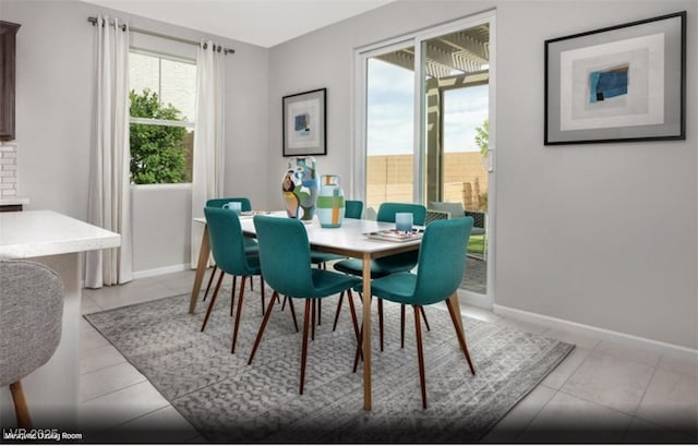 dining area with baseboards and light tile patterned flooring
