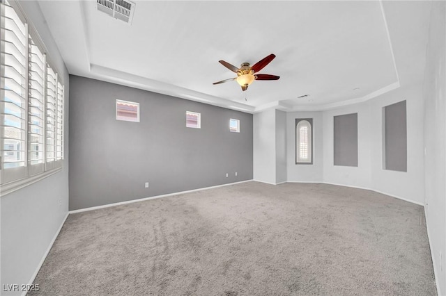 2432 Granada Bluff Ct, Las Vegas, NV 89135 - unfurnished room featuring a tray ceiling, ceiling fan, carpet flooring, and healthy amount of natural light