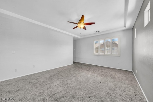 2432 Granada Bluff Ct, Las Vegas, NV 89135 - carpeted empty room featuring a ceiling fan, a raised ceiling, and baseboards