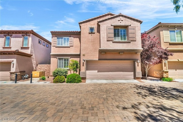 2432 Granada Bluff Ct, Las Vegas, NV 89135 - view of front of home with an attached garage, stucco siding, driveway, and a tiled roof