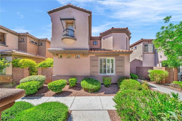 2432 Granada Bluff Ct, Las Vegas, NV 89135 - view of front of house featuring a tiled roof, fence, and stucco siding