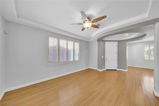 2432 Granada Bluff Ct, Las Vegas, NV 89135 - unfurnished room featuring a ceiling fan, a raised ceiling, light wood-style floors, and baseboards