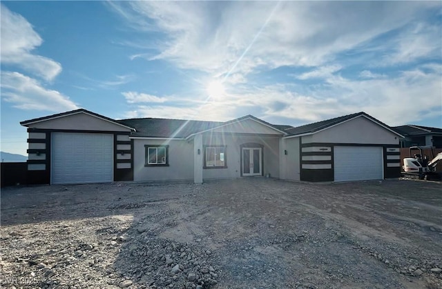1760 Omaha Ave, Pahrump, NV 89048 - ranch-style house with a garage, stucco siding, and french doors
