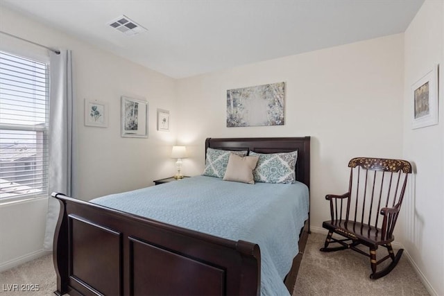 bedroom featuring light colored carpet and baseboards