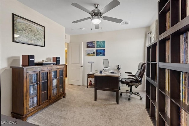 carpeted office with ceiling fan