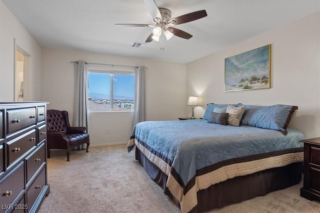 bedroom with light carpet, ceiling fan, and baseboards