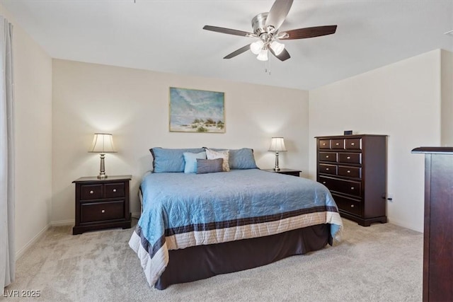 carpeted bedroom featuring baseboards and ceiling fan