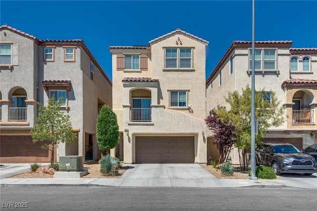 view of front of home with stucco siding, an attached garage, a tiled roof, concrete driveway, and cooling unit