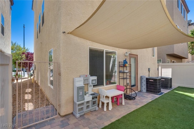 view of patio / terrace featuring fence and central air condition unit