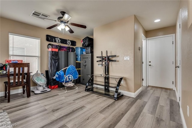 exercise area featuring light wood-style flooring, ceiling fan, baseboards, and recessed lighting
