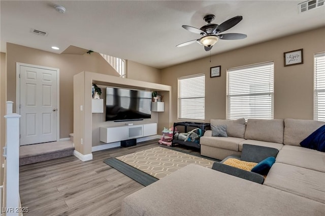 living room featuring ceiling fan, wood finished floors, baseboards, and recessed lighting