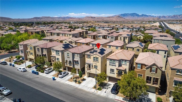 aerial view of residential area featuring mountains