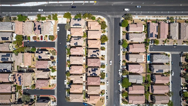 aerial view of property and surrounding area featuring nearby suburban area
