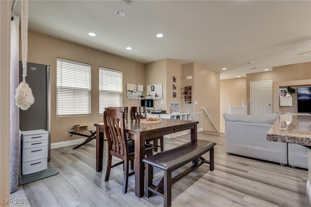 dining space featuring light wood finished floors, recessed lighting, and baseboards