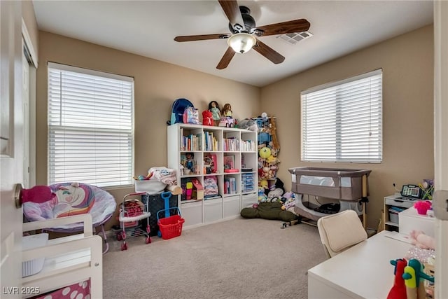 playroom featuring healthy amount of natural light, carpet, and ceiling fan