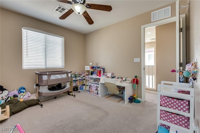 playroom with a ceiling fan and carpet flooring