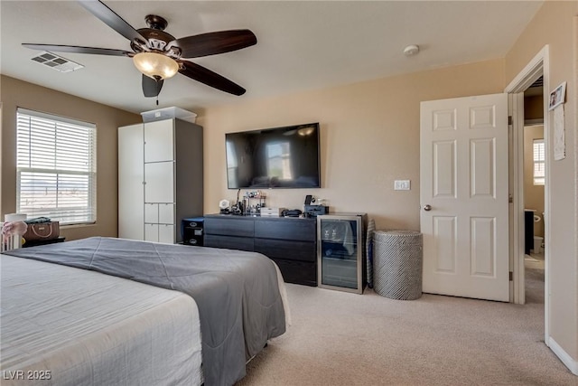 bedroom with light colored carpet and ceiling fan