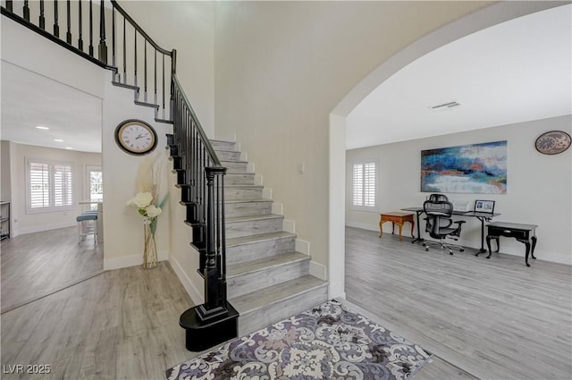 4 Tarryall Ter, Henderson, NV 89074 - stairway with arched walkways, wood finished floors, healthy amount of natural light, baseboards, and recessed lighting
