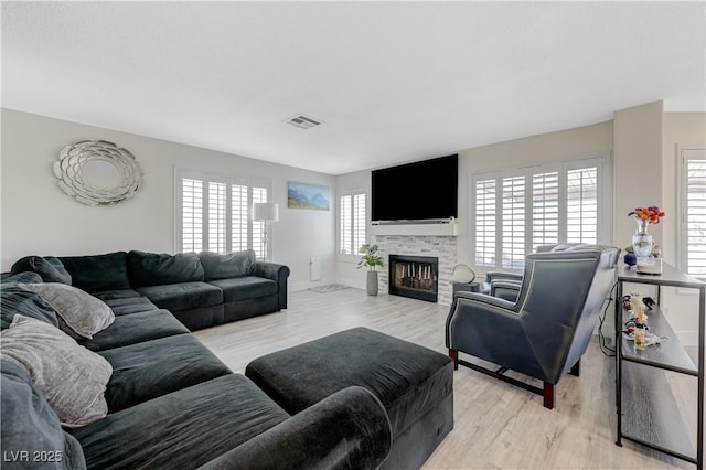 4 Tarryall Ter, Henderson, NV 89074 - living area featuring light wood finished floors, a fireplace, and baseboards