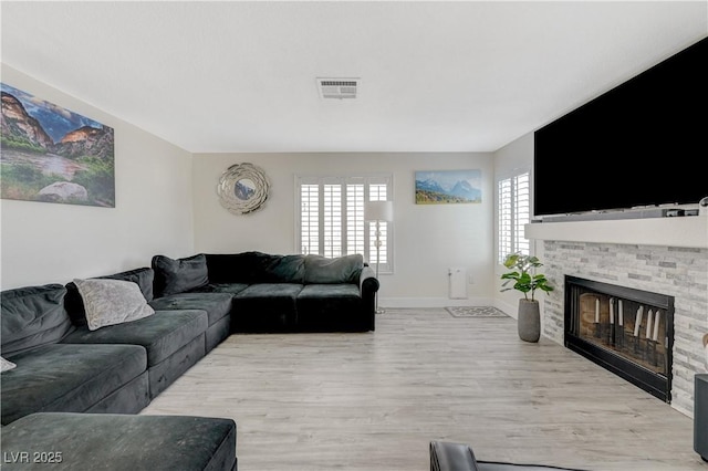 4 Tarryall Ter, Henderson, NV 89074 - living room featuring light wood-style flooring and a glass covered fireplace
