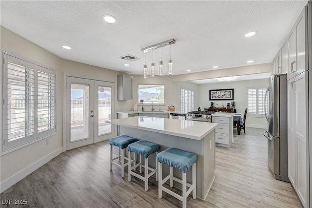 4 Tarryall Ter, Henderson, NV 89074 - kitchen featuring appliances with stainless steel finishes, a center island, a sink, light countertops, and baseboards
