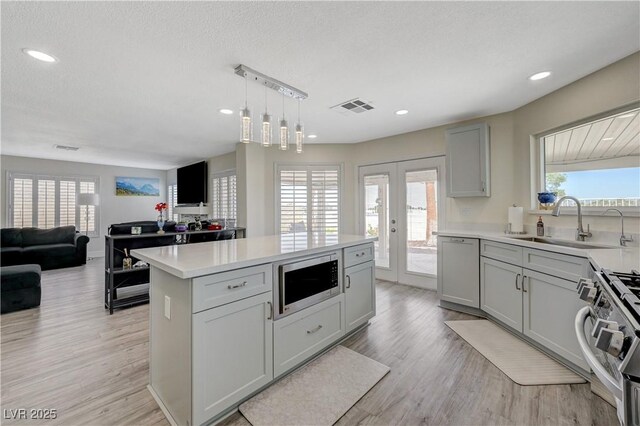 4 Tarryall Ter, Henderson, NV 89074 - kitchen with stainless steel appliances, a sink, light countertops, healthy amount of natural light, and recessed lighting
