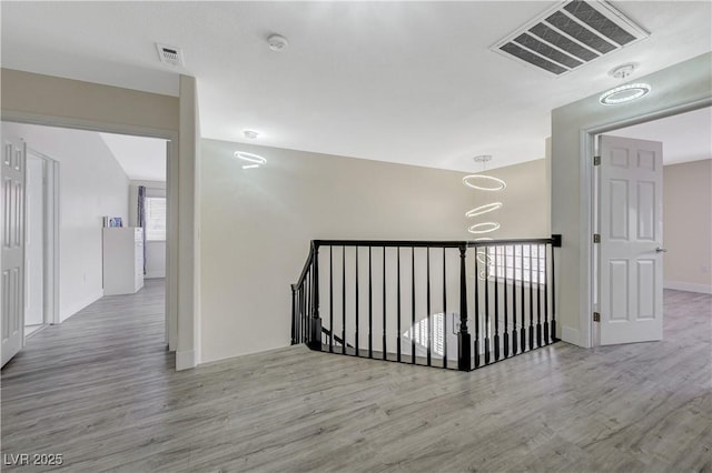 4 Tarryall Ter, Henderson, NV 89074 - hallway with wood finished floors, baseboards, and an upstairs landing