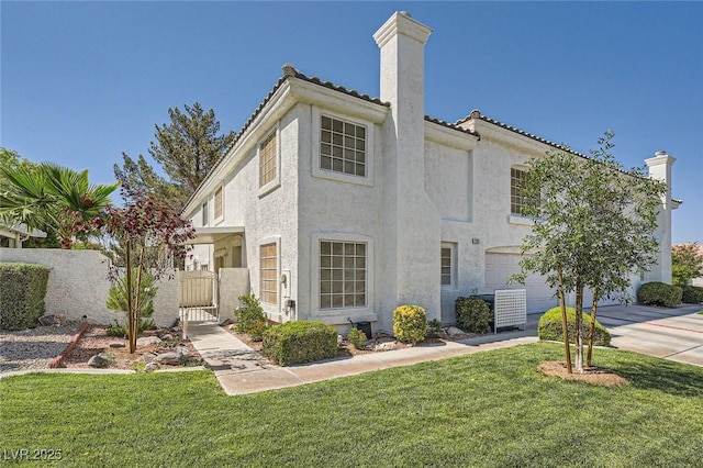 2902 Aztec Lily Ln, Henderson, NV 89074 - view of front of house with a chimney, stucco siding, a front lawn, a garage, and concrete driveway