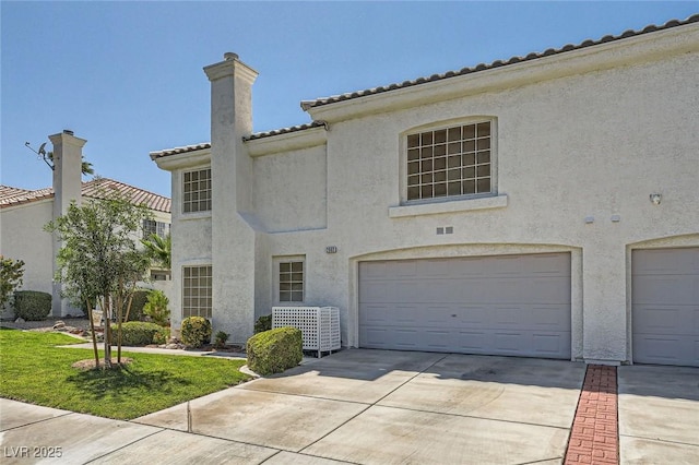 2902 Aztec Lily Ln, Henderson, NV 89074 - view of front of house with a chimney, concrete driveway, a garage, and stucco siding