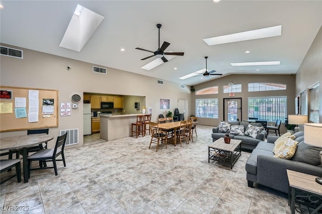 2902 Aztec Lily Ln, Henderson, NV 89074 - living room with a skylight, a ceiling fan, and high vaulted ceiling