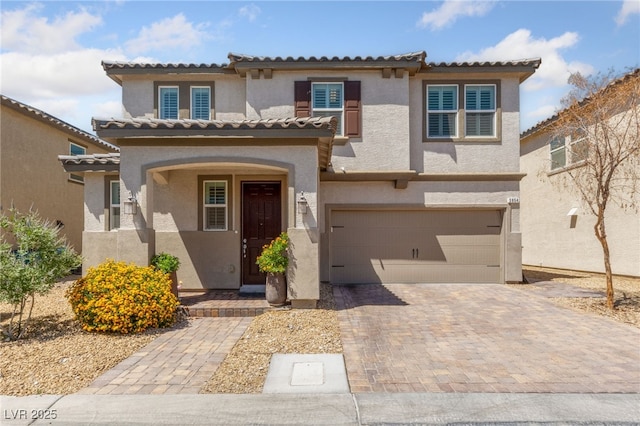3854 Stadium Ave, Las Vegas, NV 89120 - mediterranean / spanish house featuring a garage, stucco siding, driveway, and a tiled roof