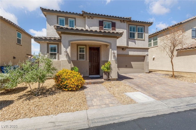 3854 Stadium Ave, Las Vegas, NV 89120 - mediterranean / spanish house featuring a garage, stucco siding, driveway, and a tiled roof
