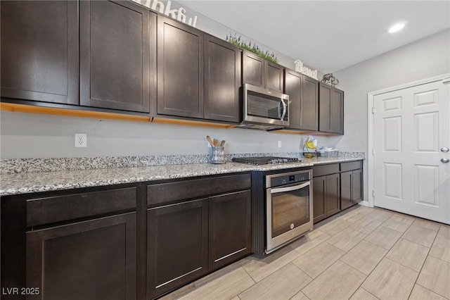 3854 Stadium Ave, Las Vegas, NV 89120 - kitchen with stainless steel appliances, dark brown cabinetry, recessed lighting, and light stone counters