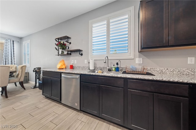 3854 Stadium Ave, Las Vegas, NV 89120 - kitchen featuring stainless steel dishwasher, light wood-style flooring, a sink, dark brown cabinetry, and open shelves