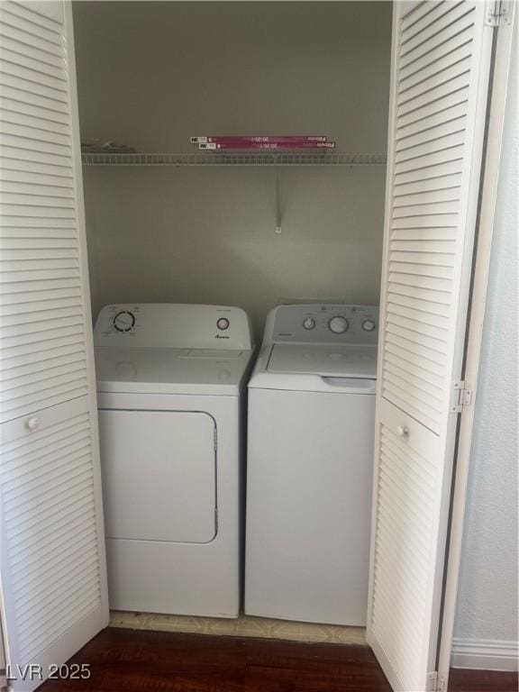 laundry area with washing machine and dryer and dark wood-style flooring