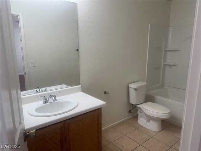 bathroom with vanity, toilet, tile patterned floors, baseboards, and tub / shower combination
