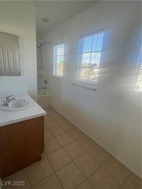 bathroom with tile patterned flooring,  shower combination, vanity, and baseboards