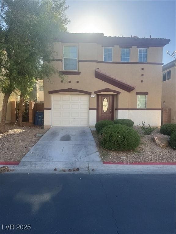 view of front of house with a garage, stucco siding, and concrete driveway