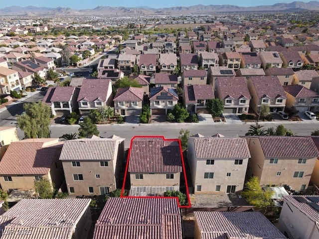 aerial view of residential area with property boundaries highlighted and a mountain backdrop
