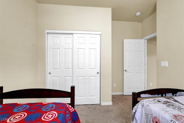 bedroom featuring carpet floors, a closet, and baseboards
