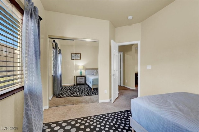bedroom featuring carpet floors, a closet, and baseboards