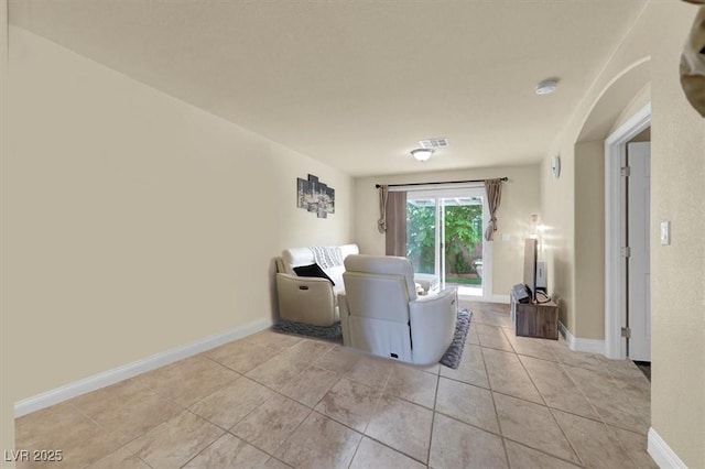living room featuring light tile patterned floors and baseboards