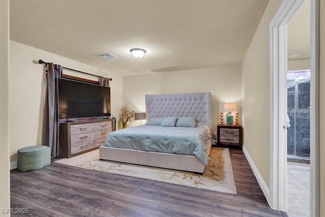 bedroom with wood finished floors and baseboards