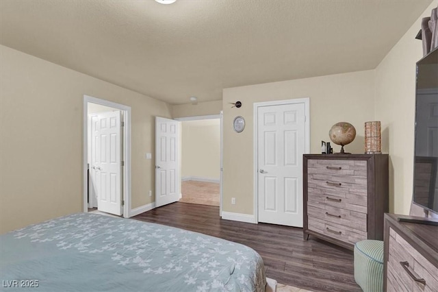 bedroom featuring dark wood-type flooring and baseboards