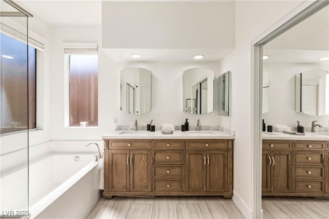 8317 Fritzen Ave, Las Vegas, NV 89131 - bathroom with a bath, double vanity, and recessed lighting