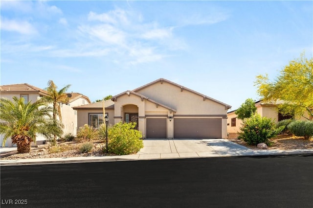 8317 Fritzen Ave, Las Vegas, NV 89131 - view of front of house with an attached garage, concrete driveway, and stucco siding