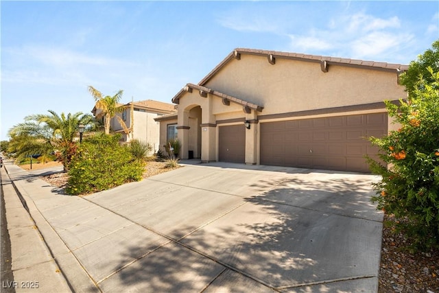 8317 Fritzen Ave, Las Vegas, NV 89131 - mediterranean / spanish home with a garage, concrete driveway, and stucco siding