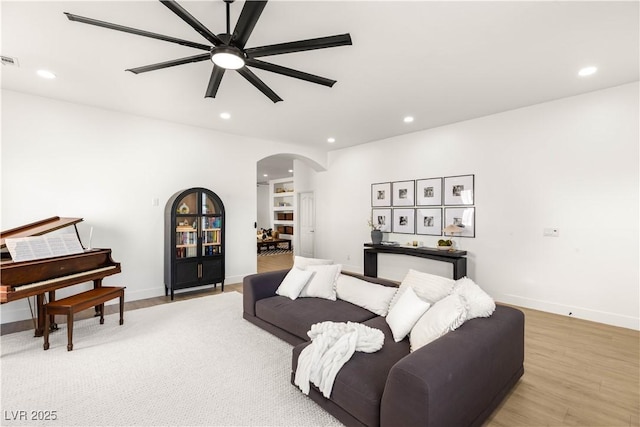 8317 Fritzen Ave, Las Vegas, NV 89131 - living room featuring arched walkways, a ceiling fan, light wood-type flooring, recessed lighting, and baseboards