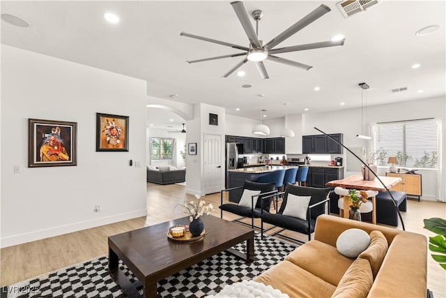8317 Fritzen Ave, Las Vegas, NV 89131 - living area featuring a ceiling fan, light wood finished floors, arched walkways, recessed lighting, and baseboards